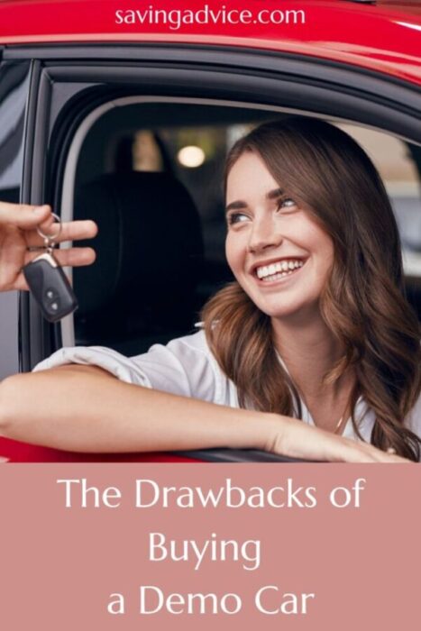 Woman in a red car smiling at a car salesman handing her a car key.