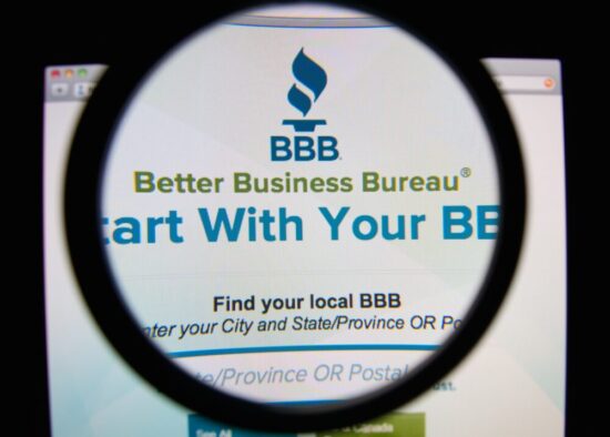 Logo of the BBB under a magnifying glass