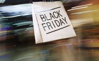 Blurred image in the background with a white piece of paper in the foreground that says "Black Friday"