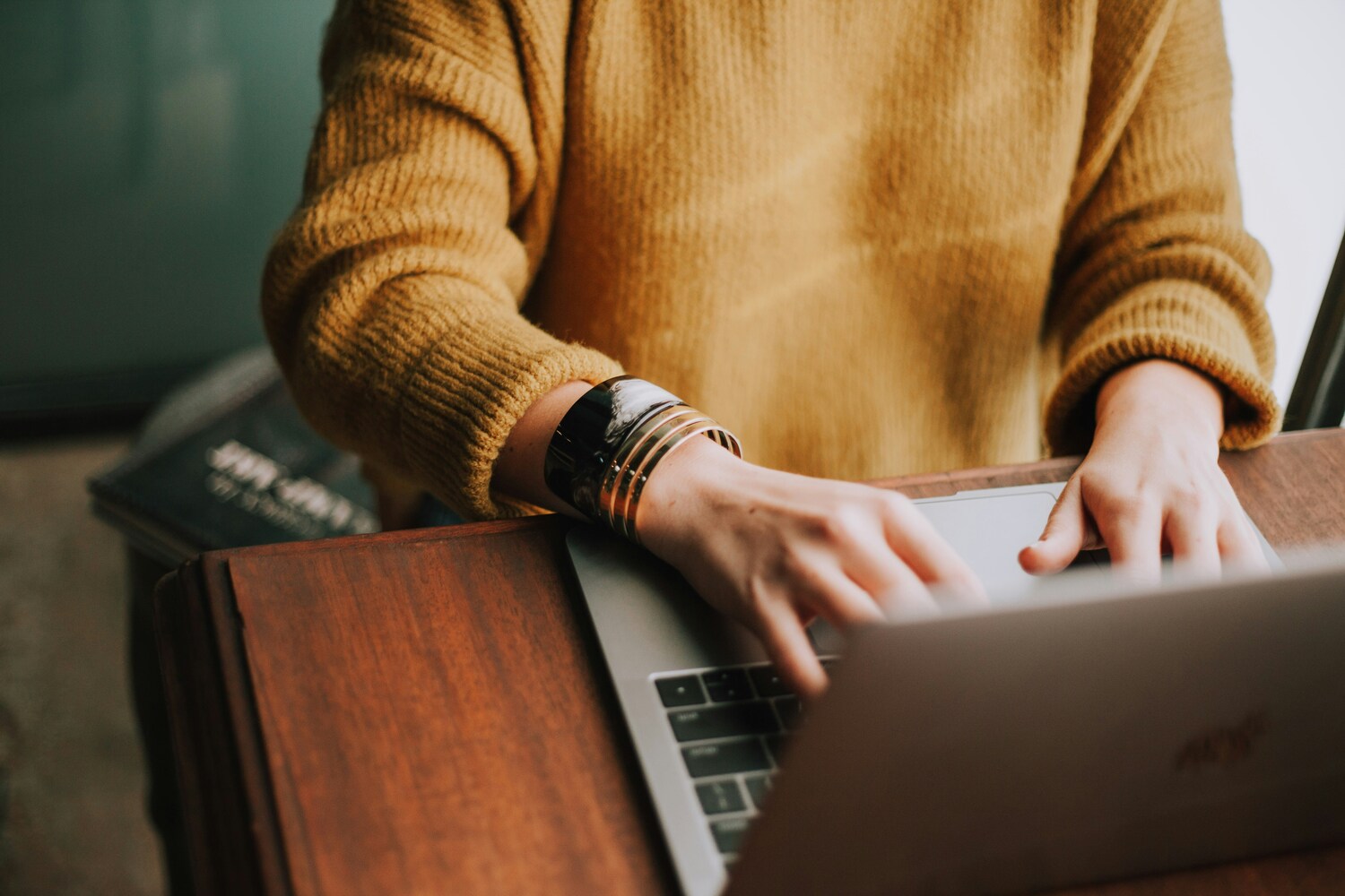 woman typing on the computer, working