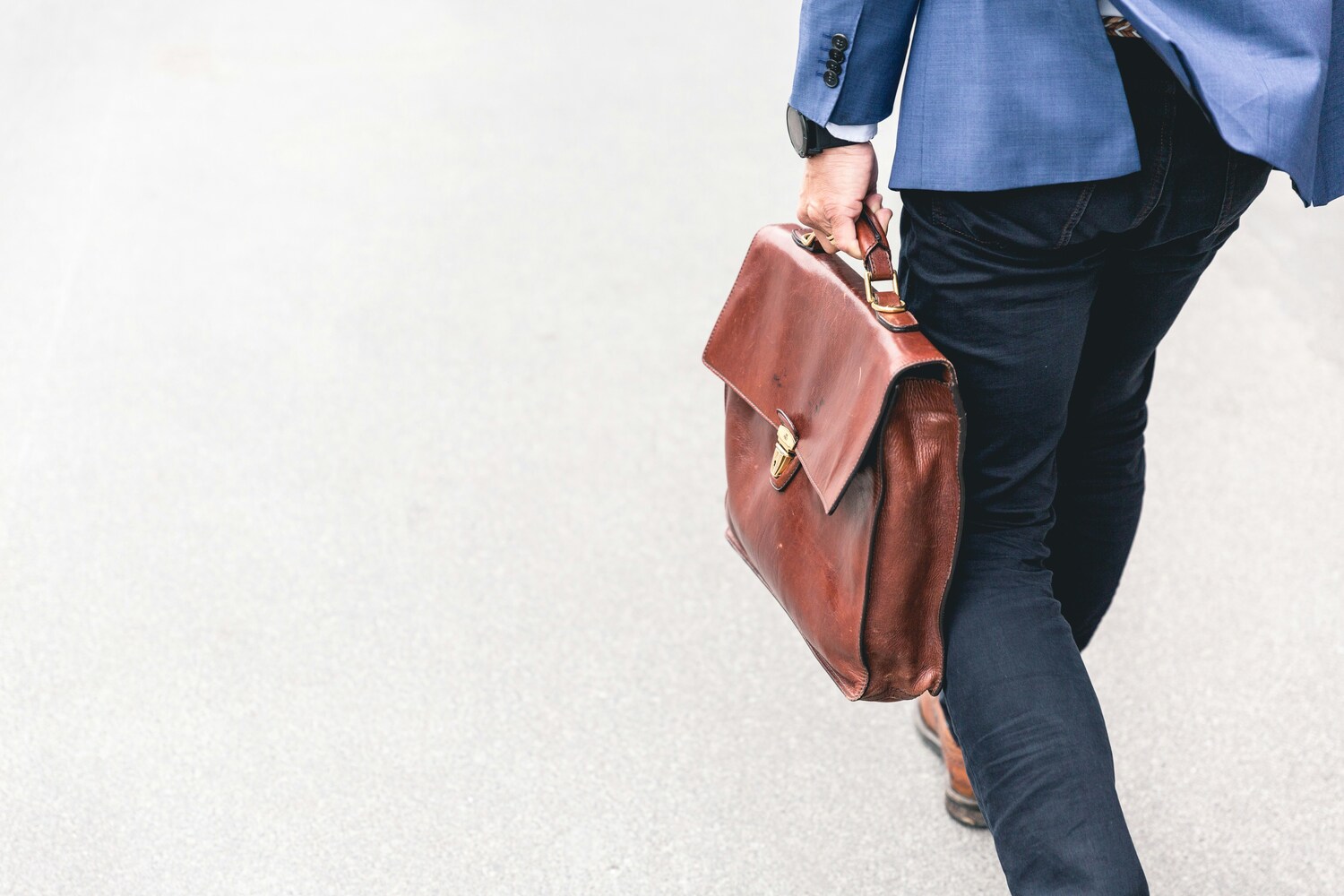 walking out of an office with a briefcase
