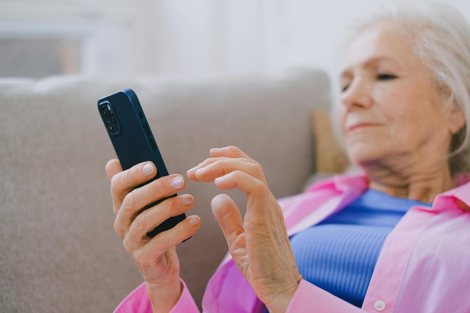 baby boomer, elderly woman sitting on the phone