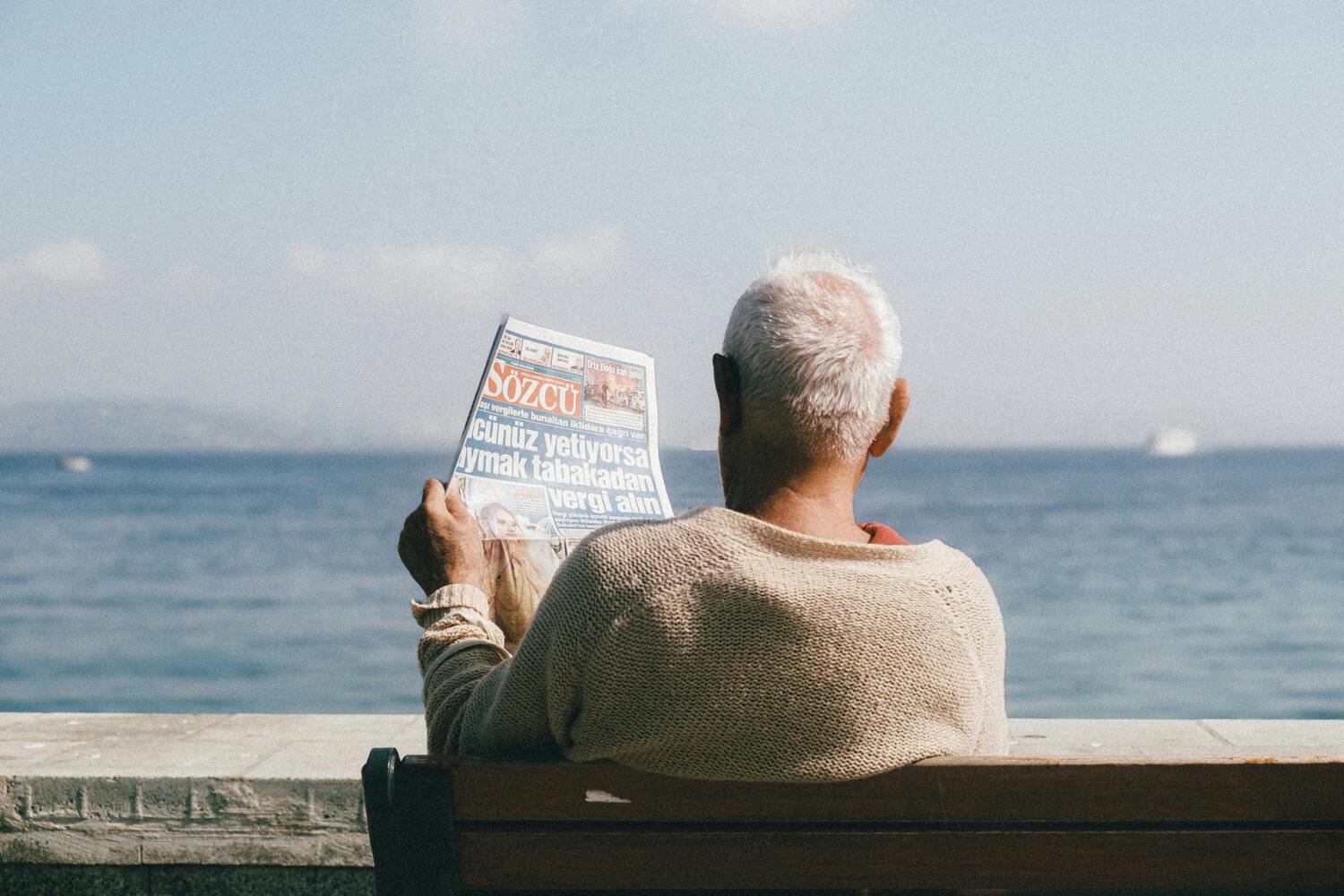 elderly gentleman sitting by the beach