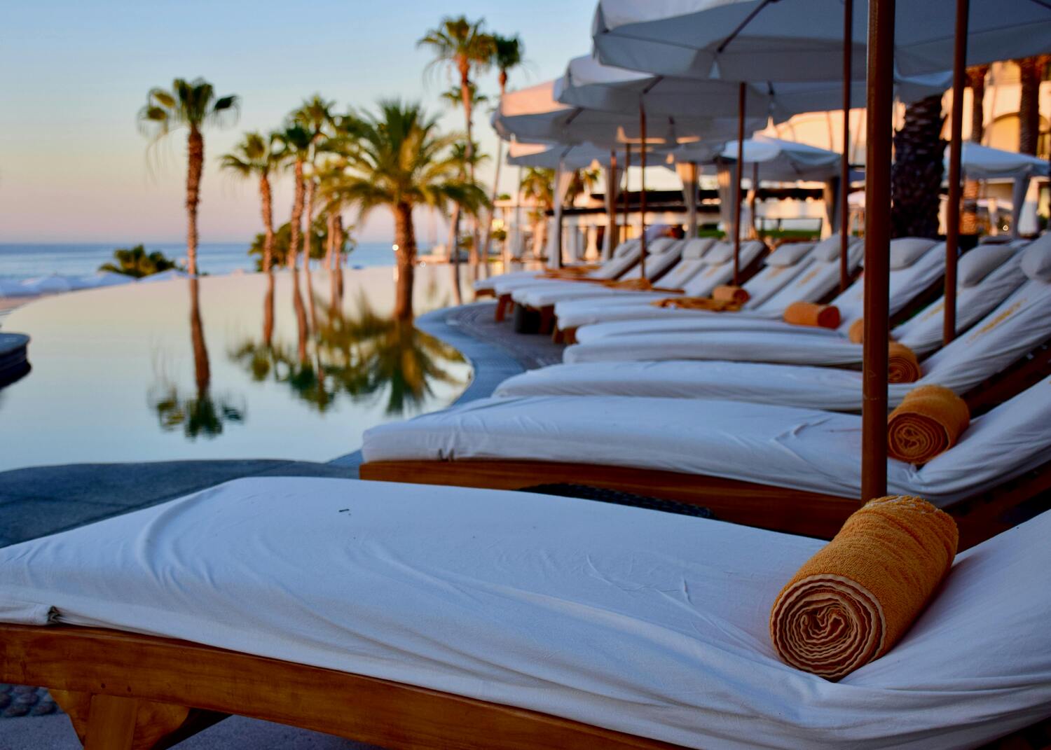 pool chairs, pool loungers by the pool overlooking the ocean