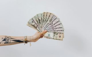 money fanned out, hand holding money