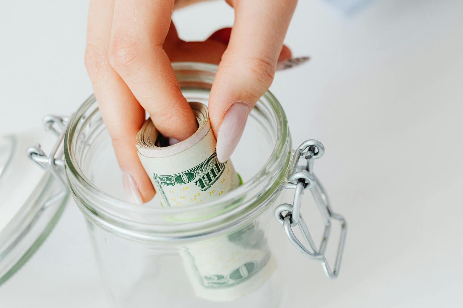 putting money in a jar, emergency fund