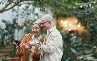 retired couple looking at phone