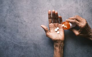 hand pouring out medication, taking medicine