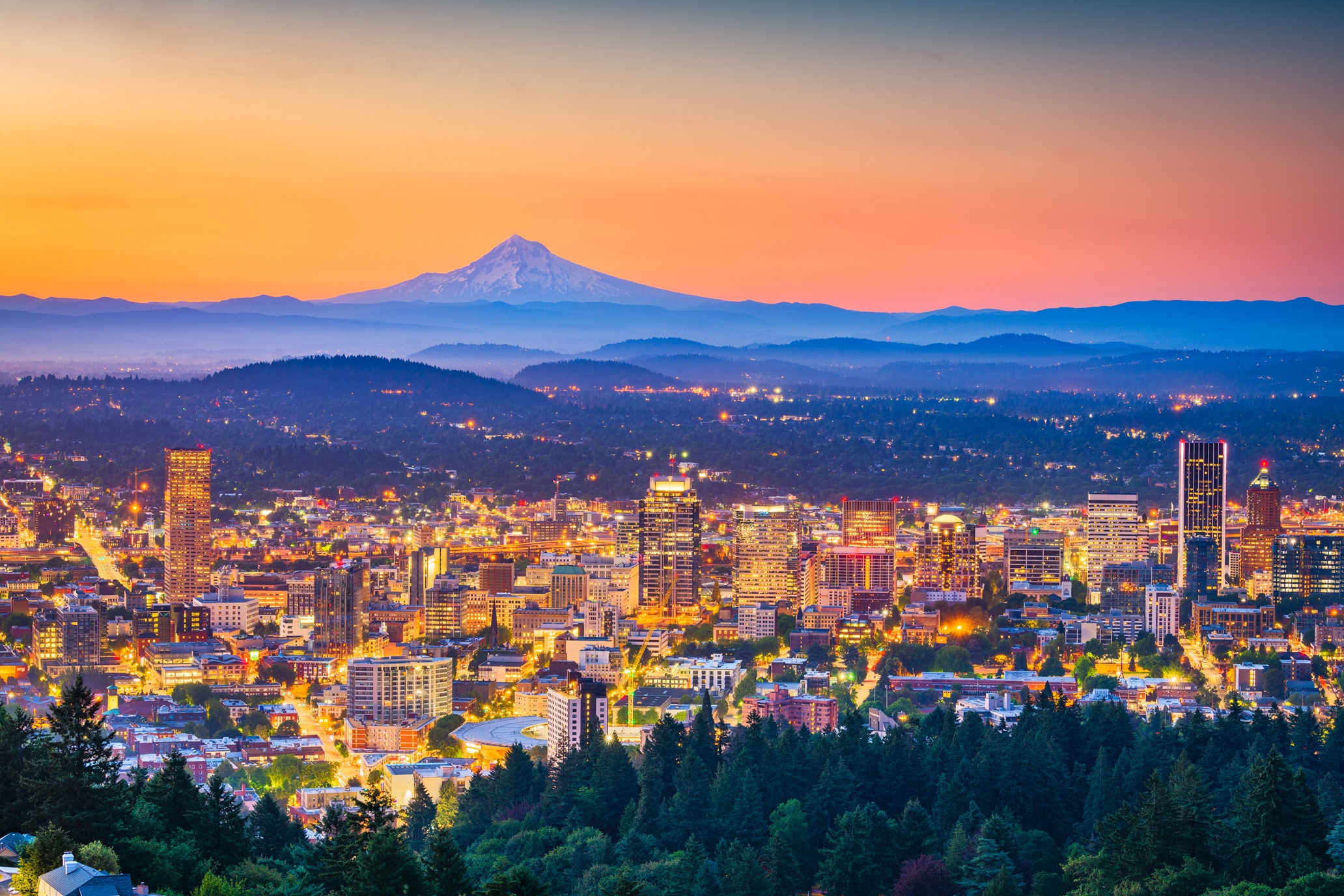 Portland, Oregon skyline with buildings and Mount Hood in the background.