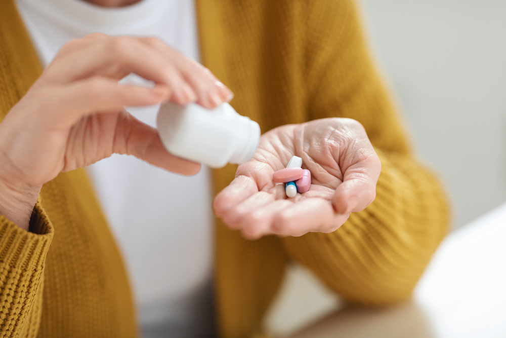 senior taking vitamins