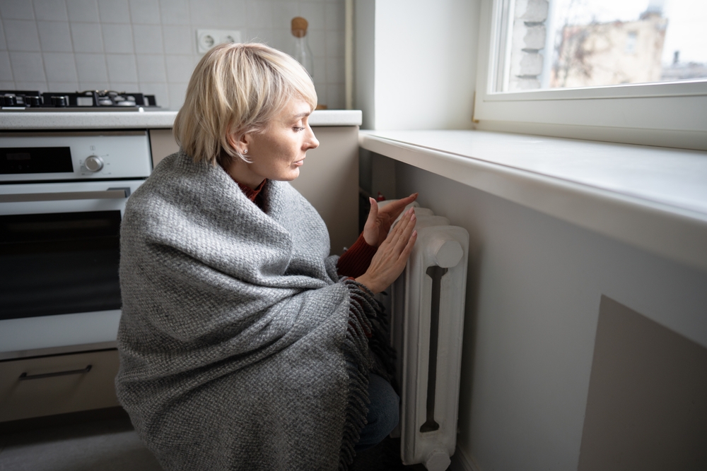 woman heating home as gas prices increase