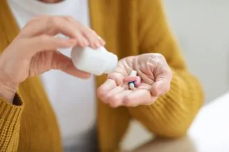 senior taking vitamins